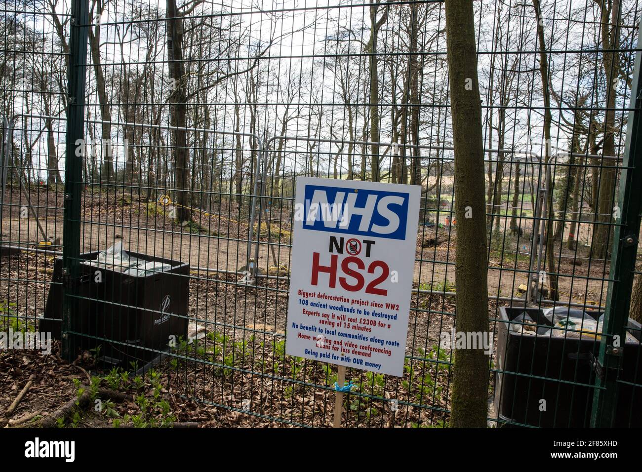 Wendover, UK. 9th April, 2021. A NHS Not HS2 placard is pictured during tree felling operations for the HS2 high-speed rail link in Jones Hill Wood, ancient woodland said to have inspired Roald Dahl. Tree felling work began this week, in spite of the presence of resting places and/or breeding sites for pipistrelle, barbastelle, noctule, brown long-eared and natterer's bats, following the issuing of a bat licence to HS2's contractors by Natural England on 30th March. Credit: Mark Kerrison/Alamy Live News Stock Photo