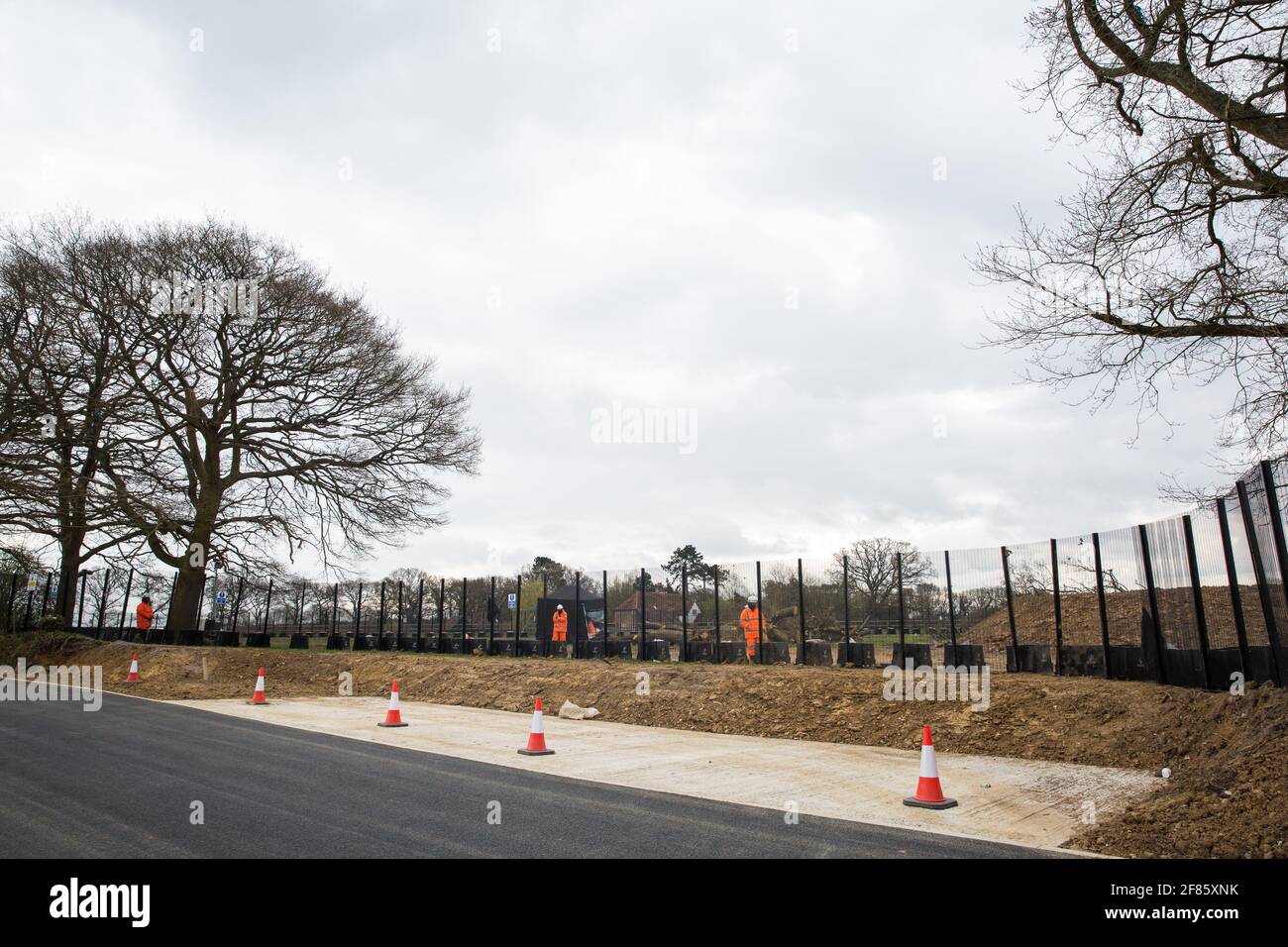 Great Missenden, UK. 9th April, 2021. HS2 security contractors guard a fenced area on Leather Lane where several hundred-year-old oak trees have been felled to enable the construction of a temporary access road and compound for the HS2 high-speed rail link. Following pressure from local residents (over 40,000 people signed a petition to save the trees), Buckinghamshire Council and the Chilterns Conservation Board, it appears that HS2's plans have been changed in such a way as to preserve some of the trees along the wildlife-rich ancient country lane. Credit: Mark Kerrison/Alamy Live News Stock Photo