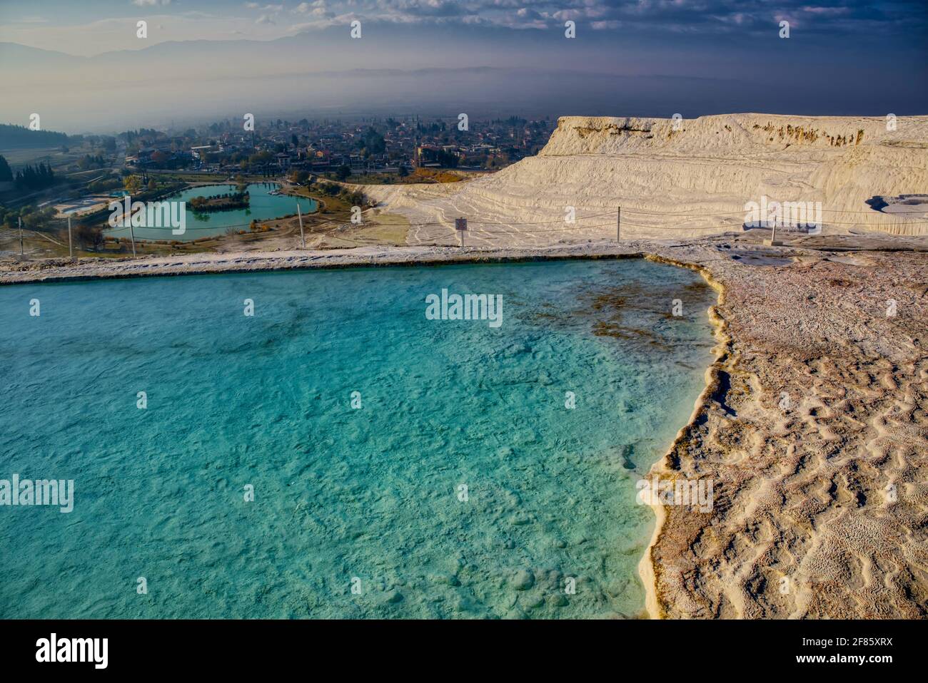 Calcite-laden waters from hot springs, emerging from a cliff almost 200 metres high overlooking the plain, have created a visually stunning landscape Stock Photo