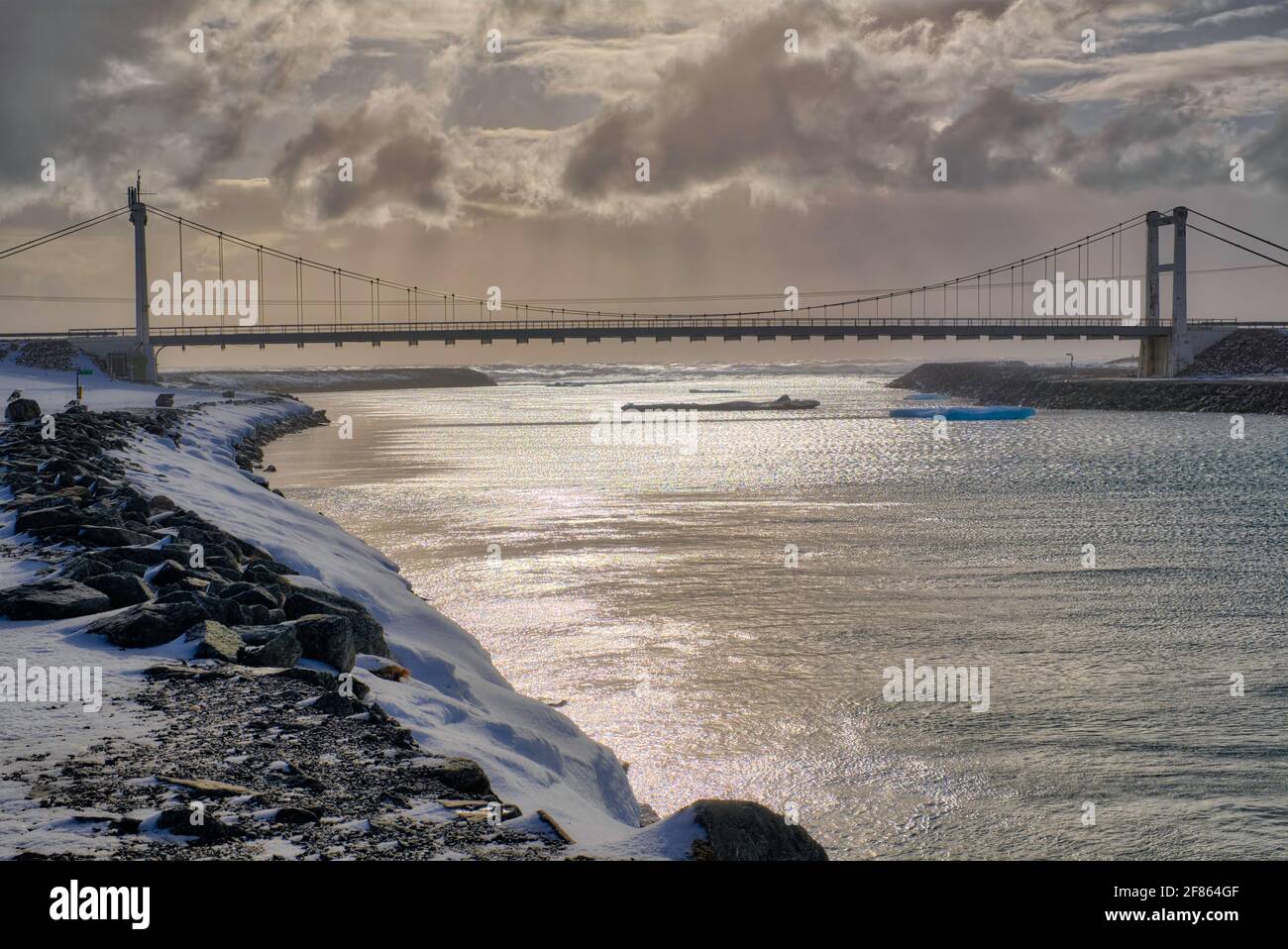 Many of the icebergs have an astounding bright blue colour and one can follow them from the Jökulsárlón glacial lagoon, where they float under the bri Stock Photo