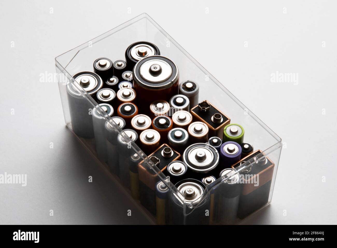 Various disposable batteries placed in organized plastic box Stock