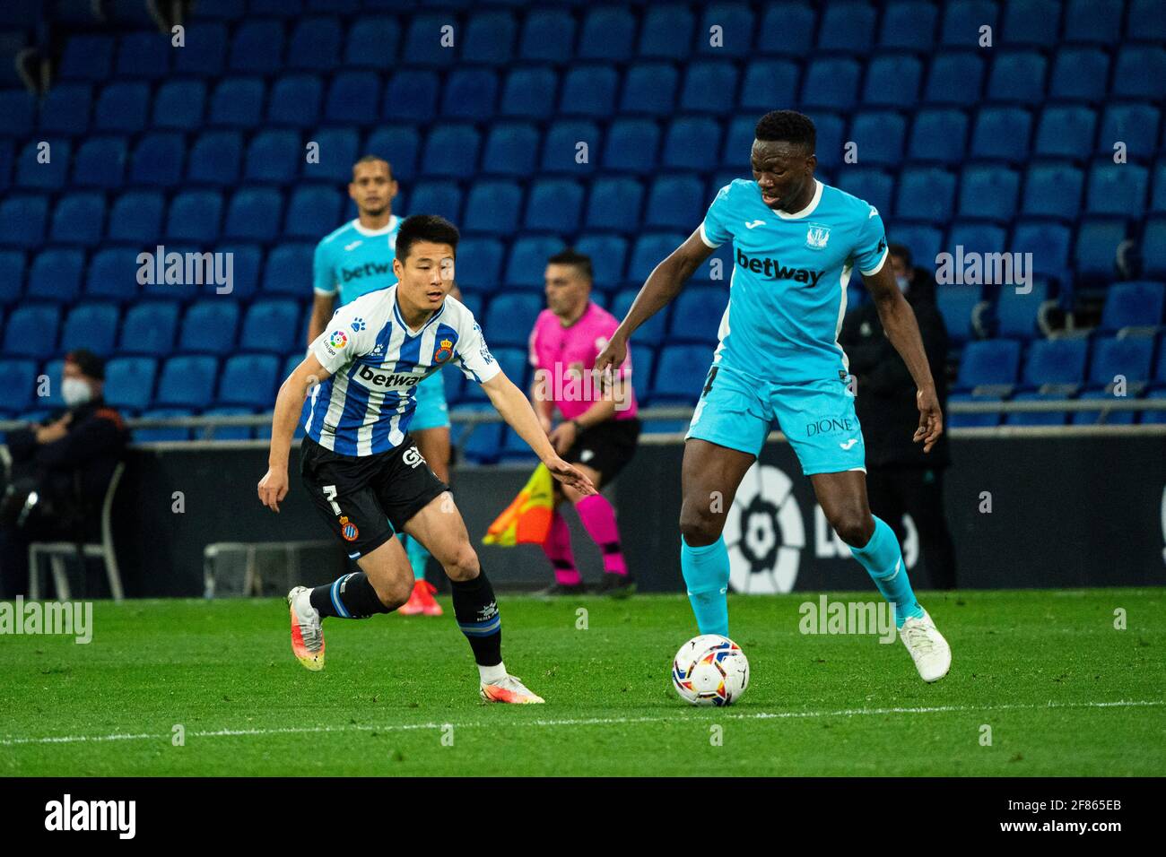 Cornella, Spain. 11th Apr, 2021. RCD Espanyol's Wu Lei (L) vies with Leganes' Kenneth Omeruo during a Spanish second division league football match between RCD Espanyol and CD Leganes in Cornella, Spain, April 11, 2021. Credit: Joan Gosa/Xinhua/Alamy Live News Stock Photo
