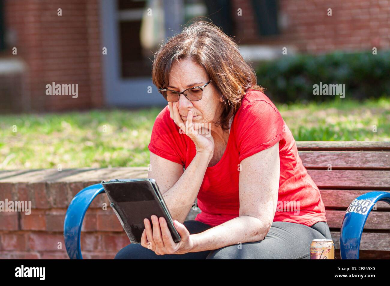 Reading newspaper tablet outdoor hires stock photography and images