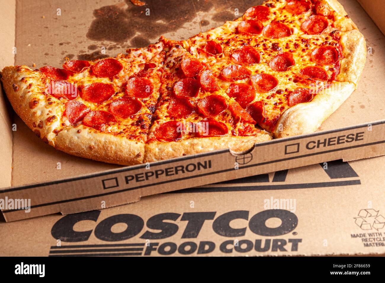 Clarksburg, MD, USA 04-07-2021: Close up isolated image of delicious fresh made pepperoni pizza sliced and placed in  cardboard box. It is a popular f Stock Photo