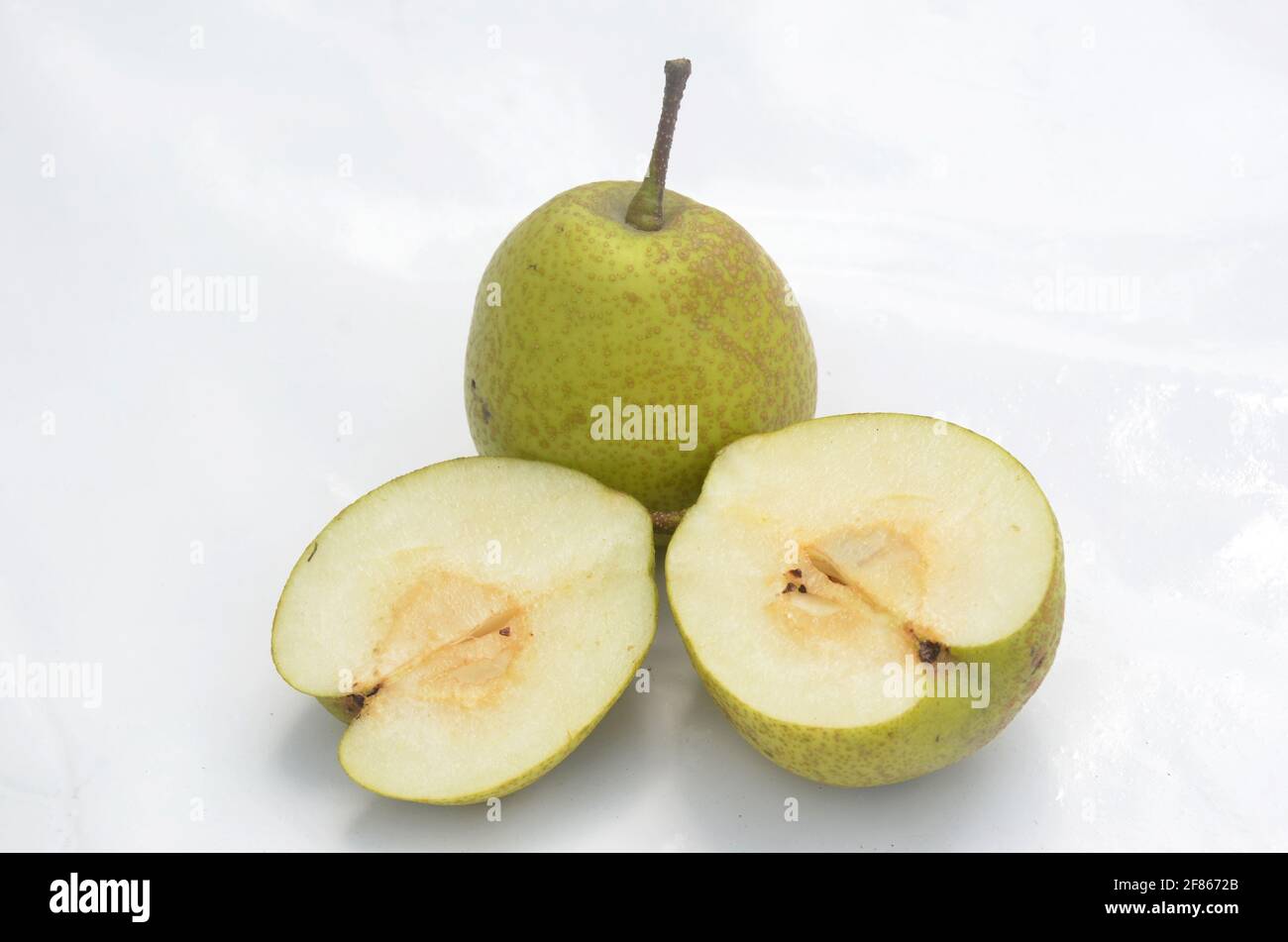 Closeup of green pear isolated on white background Stock Photo - Alamy