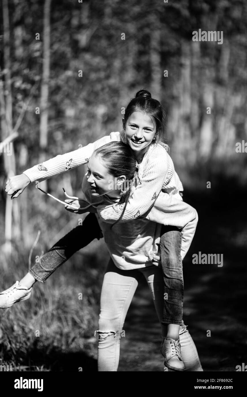 Two teen girl fooling outdoors. Black and white photo Stock Photo - Alamy
