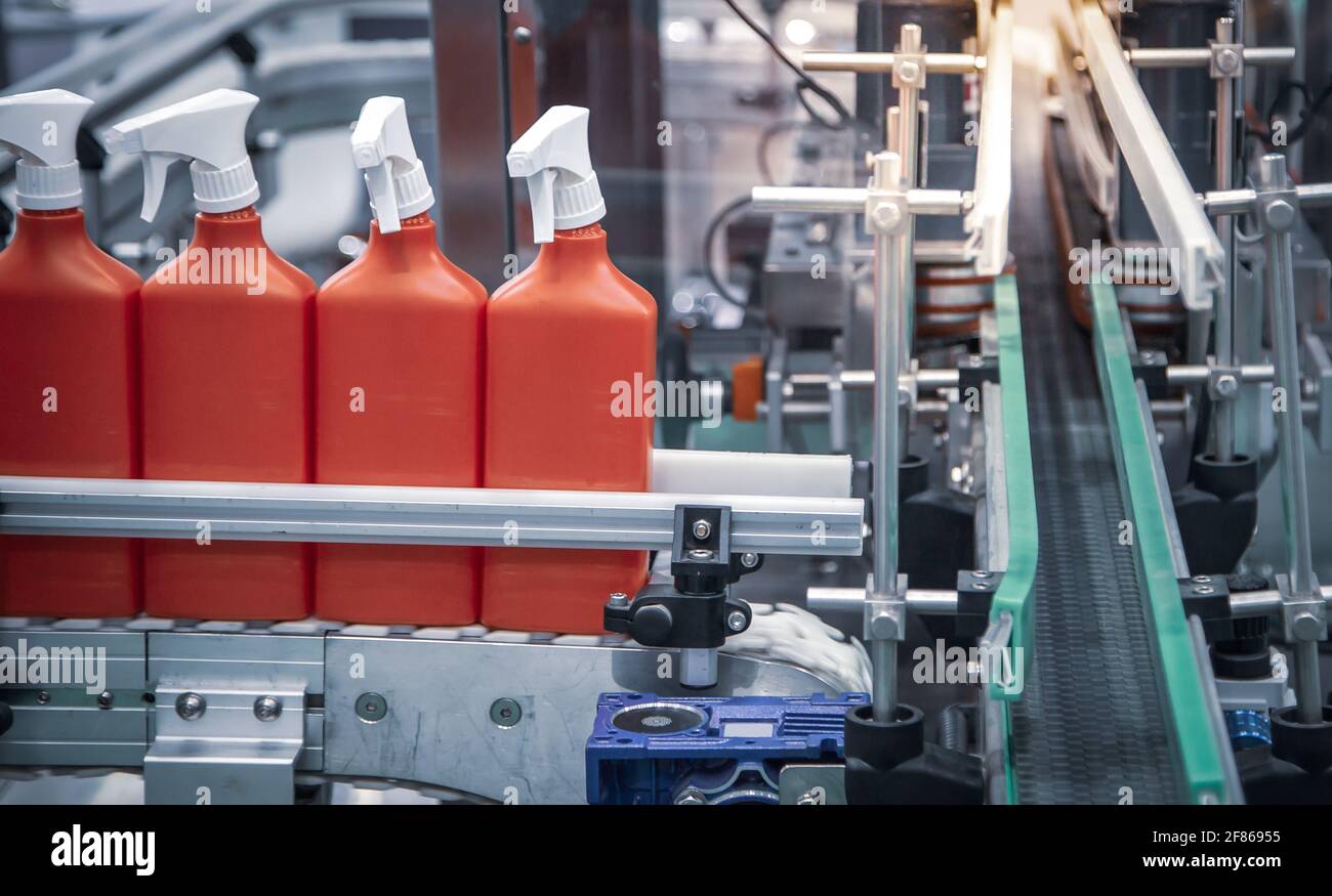 Production line of foggy spray bottle filling and capping machine. Stock Photo