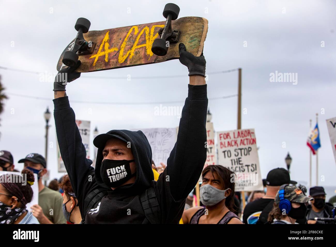 Los Angeles, California, USA. 11th Apr, 2021. A counter protester holds a skateboard up during a counter protest to a planned White Lives Matter rally at the Huntington Beach Pier. Credit: Jill Connelly/ZUMA Wire/Alamy Live News Stock Photo
