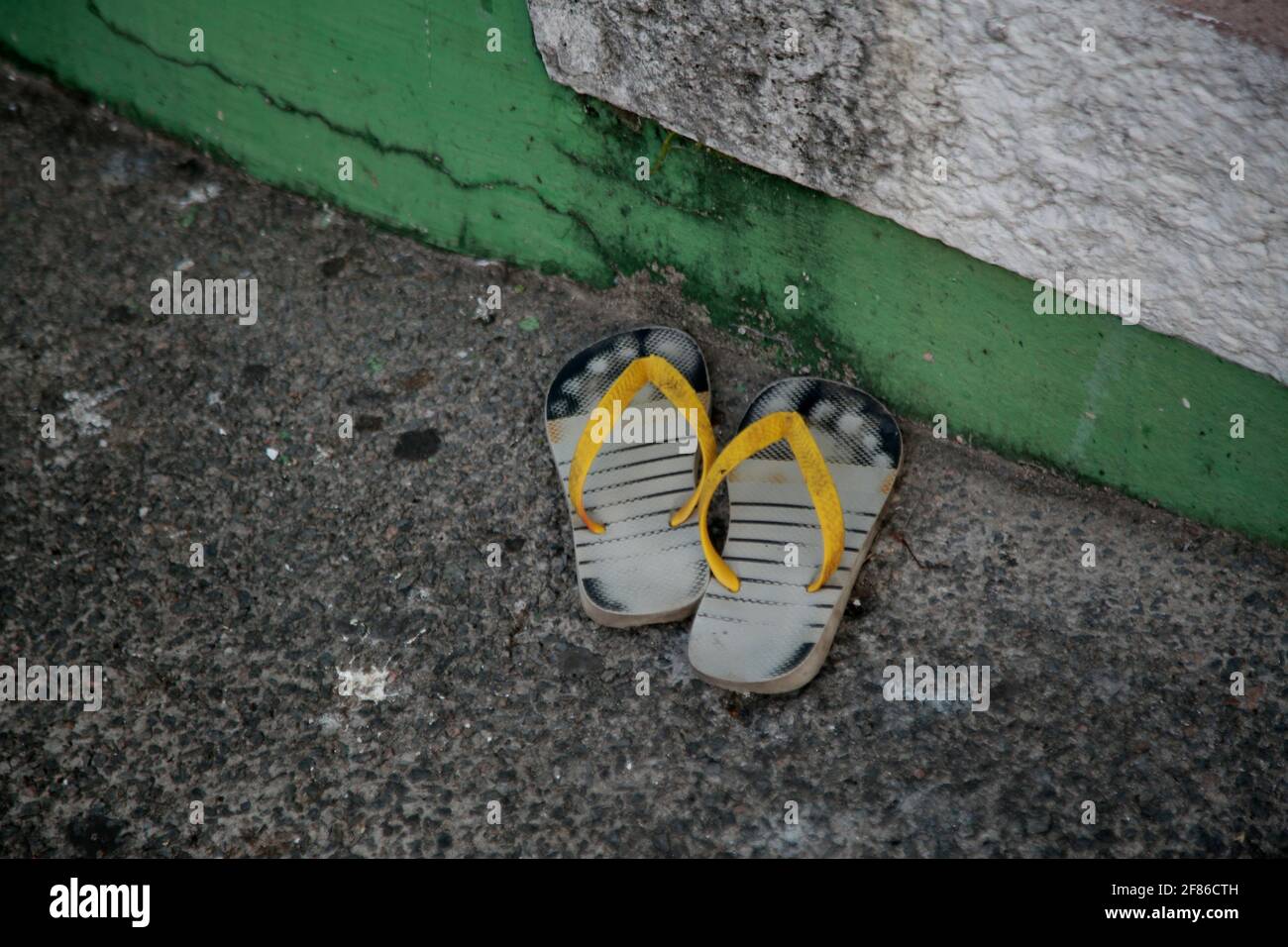 salvador, bahia, brazil - december 16, 2020: old rubber sandals are seen abandoned on a sidewalk in the city of Salvador. *** Local Caption *** Stock Photo