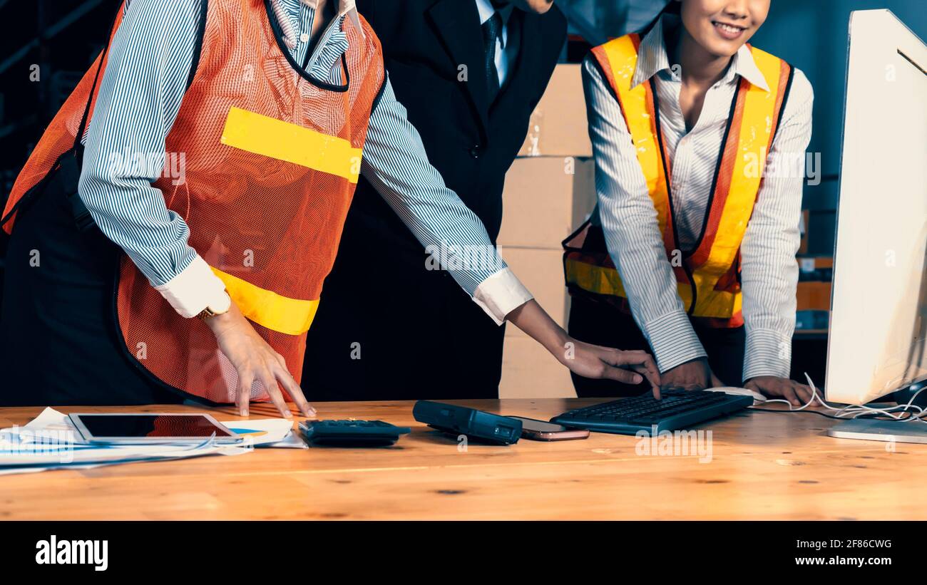Warehouse manager and worker working in the storehouse . Logistics