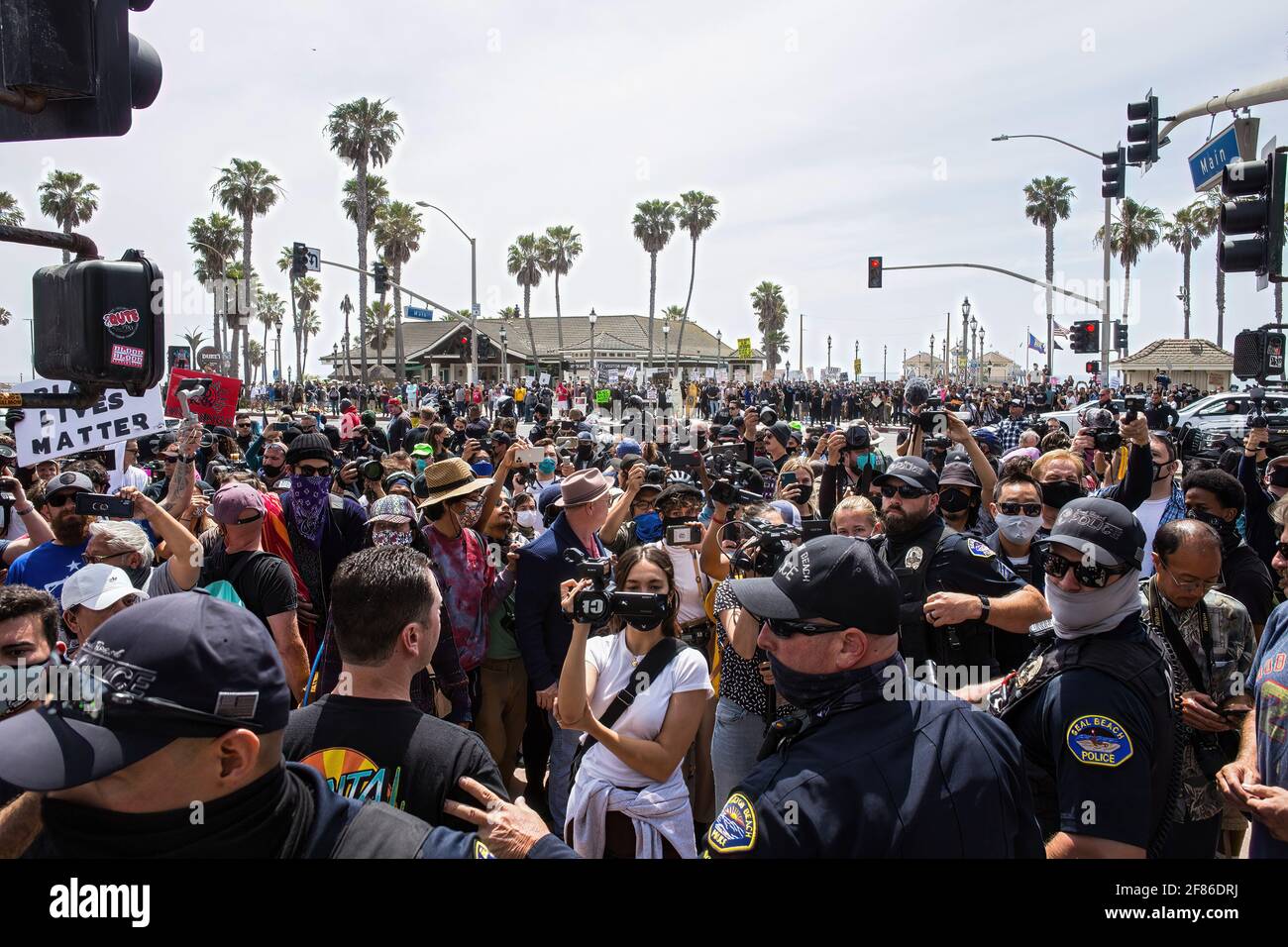 Huntington Beach, United States. 11th Apr, 2021. Crowds of protesters and counter-protesters gather in front of the Huntington Beach Pier during the demonstration. Upon word spreading amongst various social media and messaging platforms that there was to be a 'White Lives Matter' protest at the Huntington Beach Pier at 1pm, a large group of counter protesters arrived at the pier to stop the 'White Lives Matter' protest. The day resulted to clashes between counter protesters and white lives matter protesters both verbal and physical. Credit: SOPA Images Limited/Alamy Live News Stock Photo