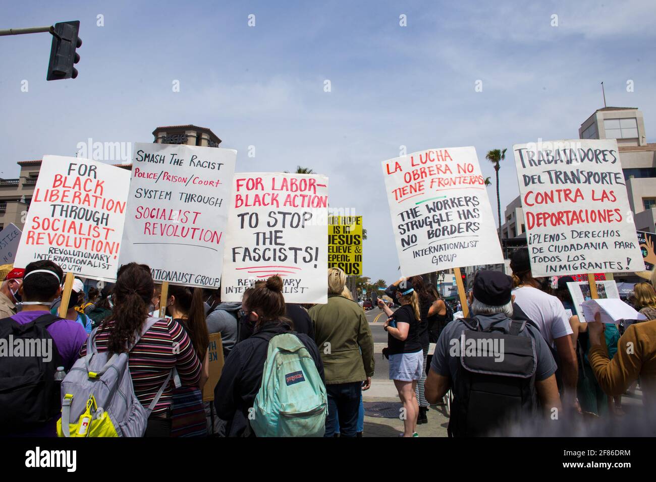 Huntington Beach, United States. 11th Apr, 2021. White Lives Matter counter protesters hold placards that call for a socialist revolution during the demonstration. Upon word spreading amongst various social media and messaging platforms that there was to be a 'White Lives Matter' protest at the Huntington Beach Pier at 1pm, a large group of counter protesters arrived at the pier to stop the 'White Lives Matter' protest. The day resulted to clashes between counter protesters and white lives matter protesters both verbal and physical. Credit: SOPA Images Limited/Alamy Live News Stock Photo