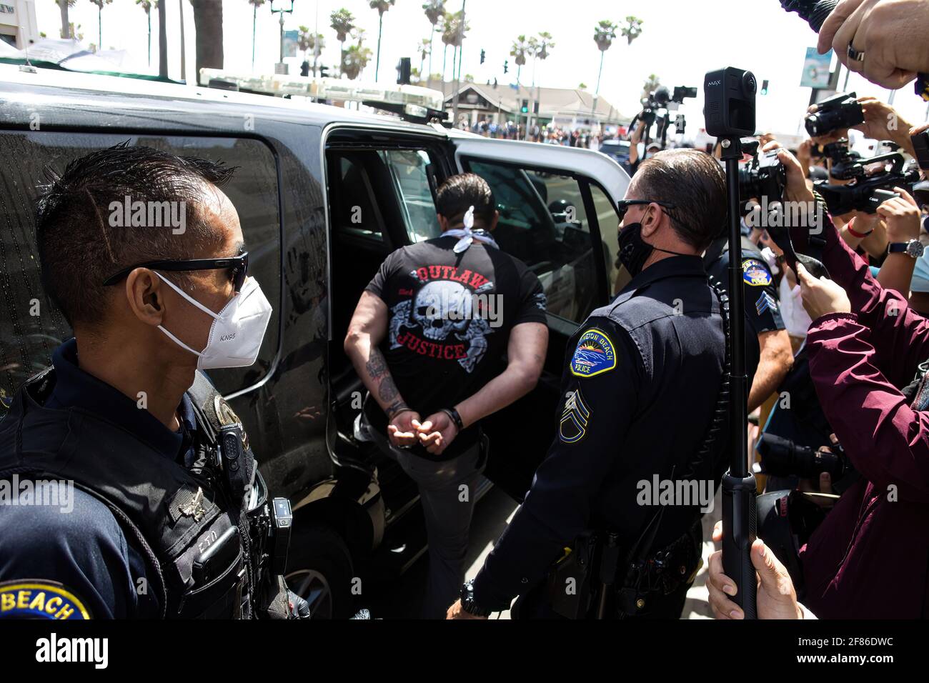 A White Lives Matter protester is being arrested after partaking in a physical altercation with counter-protesters during the demonstration. Upon word spreading amongst various social media and messaging platforms that there was to be a 'White Lives Matter' protest at the Huntington Beach Pier at 1pm, a large group of counter protesters arrived at the pier to stop the 'White Lives Matter' protest. The day resulted to clashes between counter protesters and white lives matter protesters both verbal and physical. Stock Photo