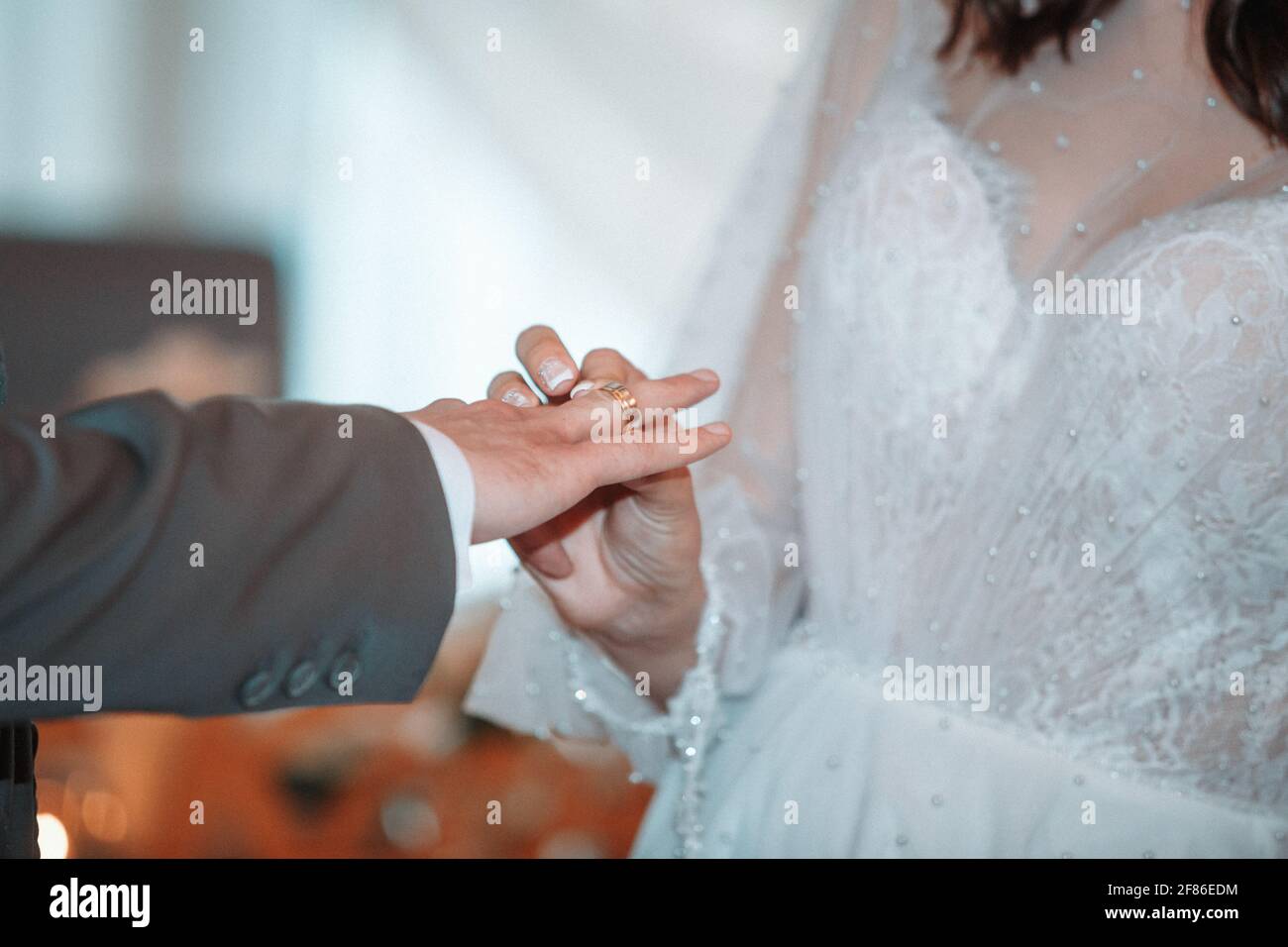 wedding ceremony, the bride and groom wear wedding rings Stock Photo ...
