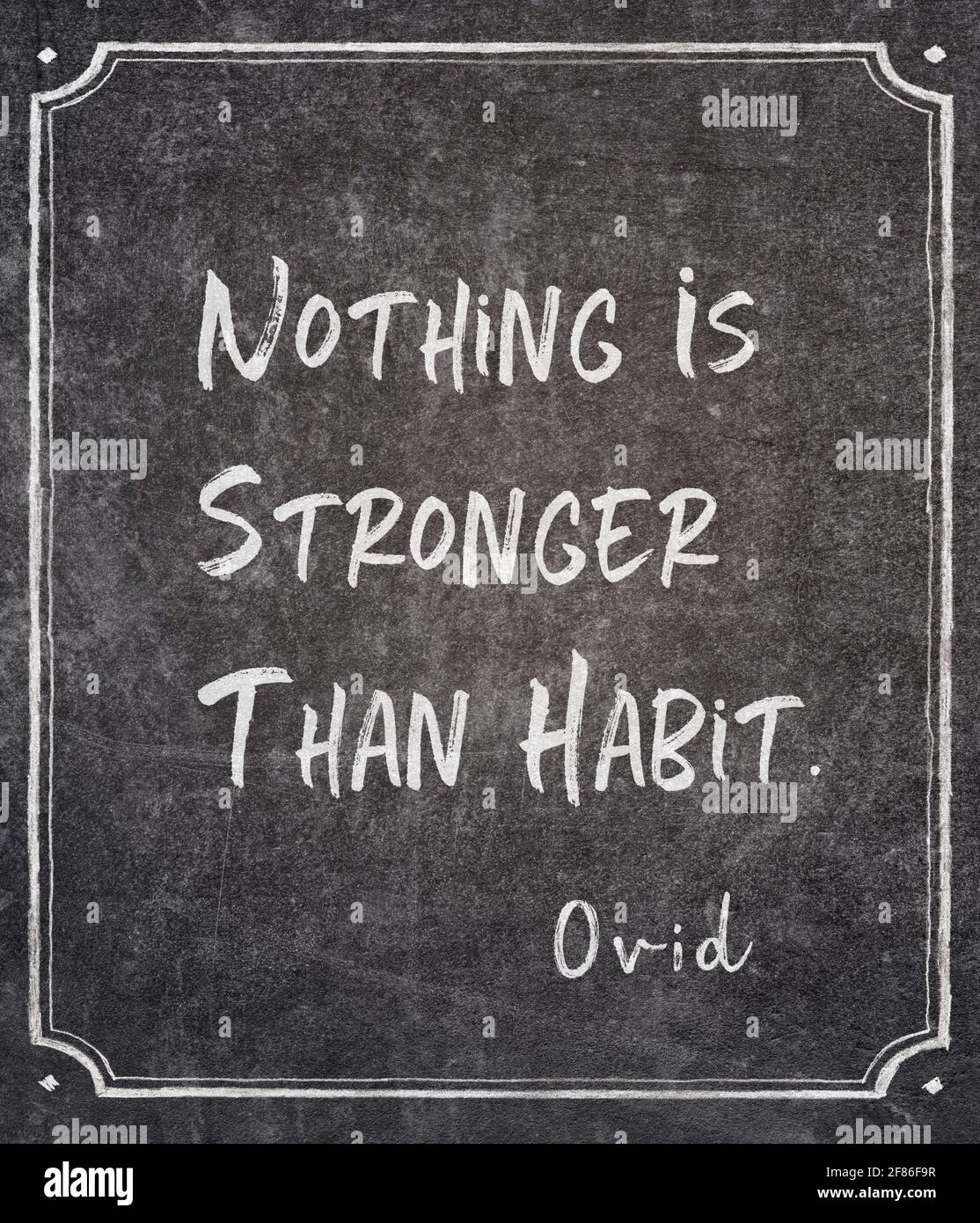 Nothing is stronger than habit - ancient Roman philosopher and poet Ovid quote written on framed chalkboard Stock Photo
