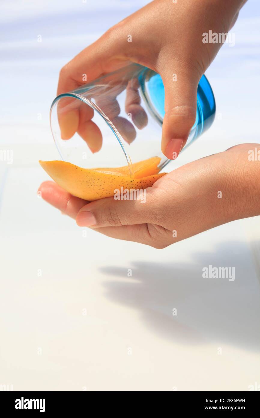 Mango being cut and prepared with 2 hands Stock Photo - Alamy