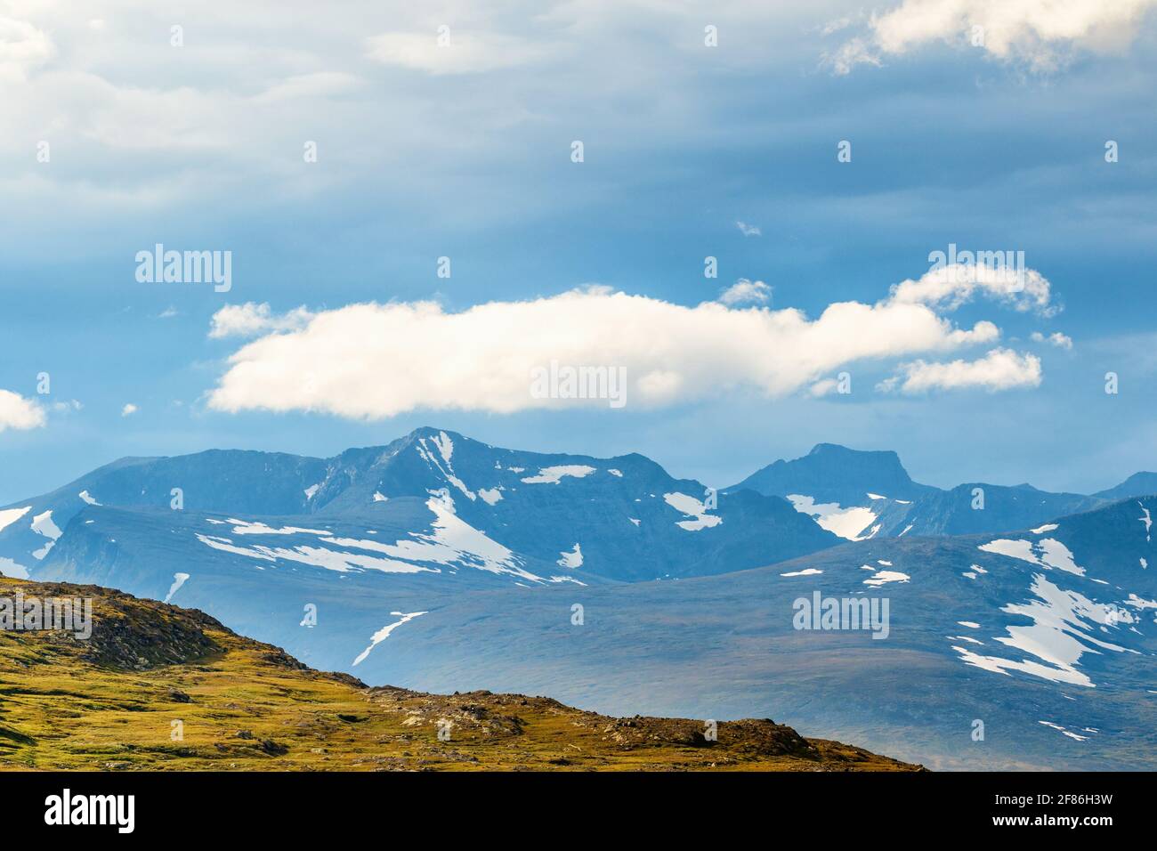 View of a mountain landscape with cloud formations Stock Photo