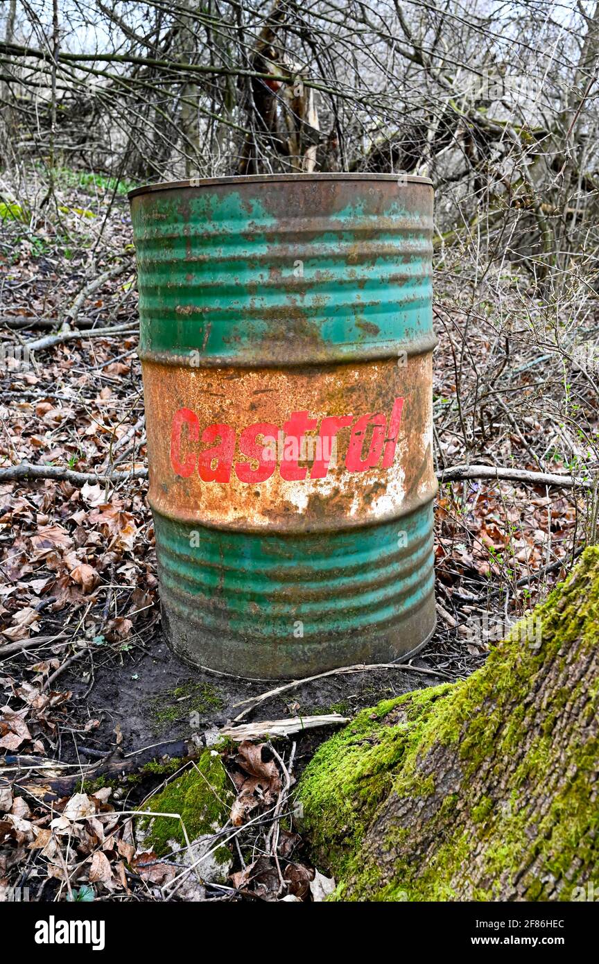 old rusty Castrol oil barrel dumped Swedish forest Stock Photo