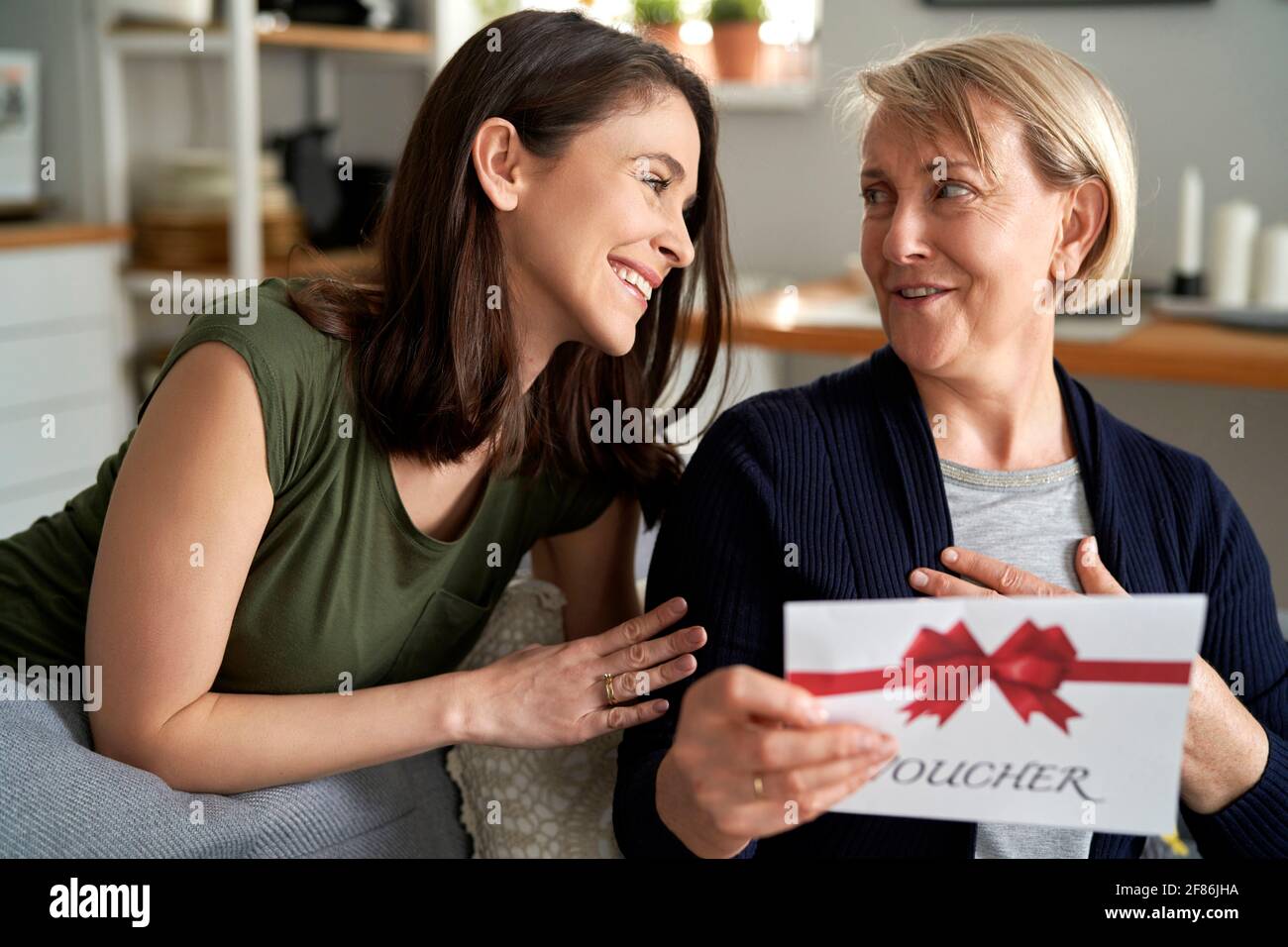 Mother is surprised by the gift from her daughter Stock Photo