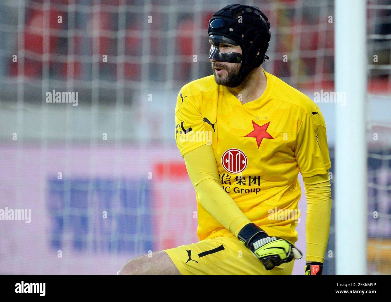 Prague, Czech Republic. 11th Apr, 2021. Goalkeeper Ondrej Kolar (Slavia) in action during 26th round of Czech First League, match SK Slavia Praha vs AC Sparta Praha, on April 11, 2021, in Prague, Czech Republic. Kolar wears a protective helmet and mask after the injury from March 18, 2021. Credit: Katerina Sulova/CTK Photo/Alamy Live News Stock Photo