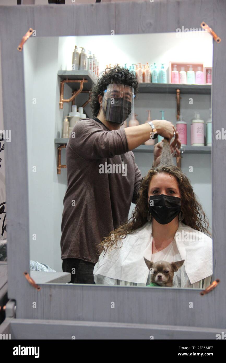 Stylist Danny Law with customer Amy Smith, who is visiting a hairdresser  for the first time in more than a year, at the Strand & Lock salon in  Birmingham's creative Digbeth quarter ,
