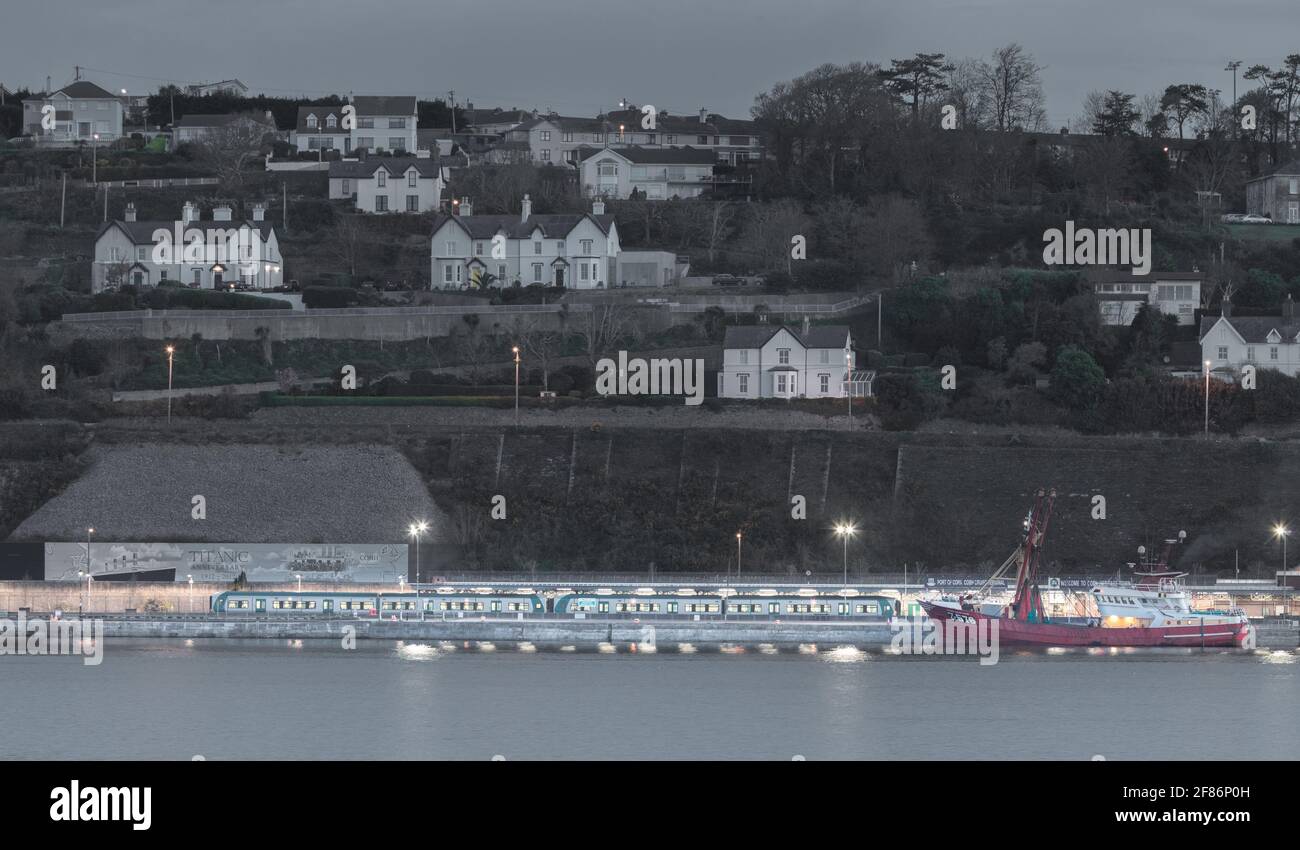 Cobh, Cork, Ireland. 12th April, 2021. An early morning commuter trains waits at the station for departure to the city, close to where the Belguim trawler Mare Nostrum is tied up at the quayside in Cobh, Co. Cork, Ireland. - Credit; David Creedon / Alamy Live News Stock Photo