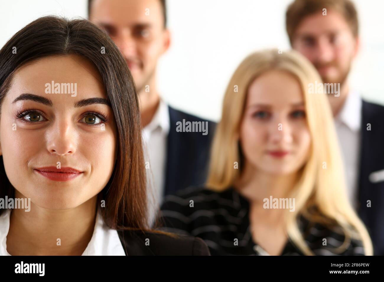 Group of smiling people stand in office looking in camera Stock Photo ...