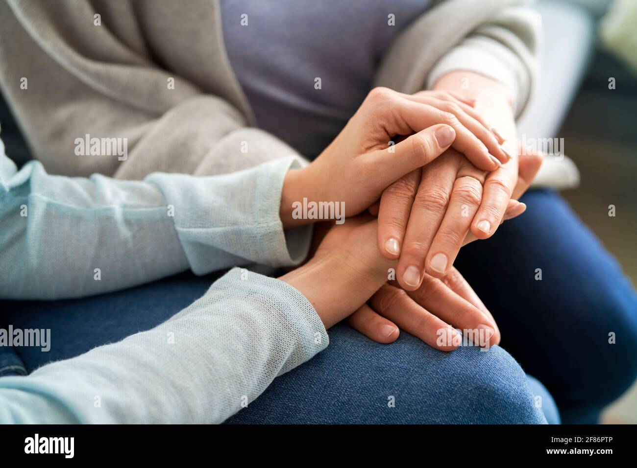 Close up of holding hands in a sign of support Stock Photo