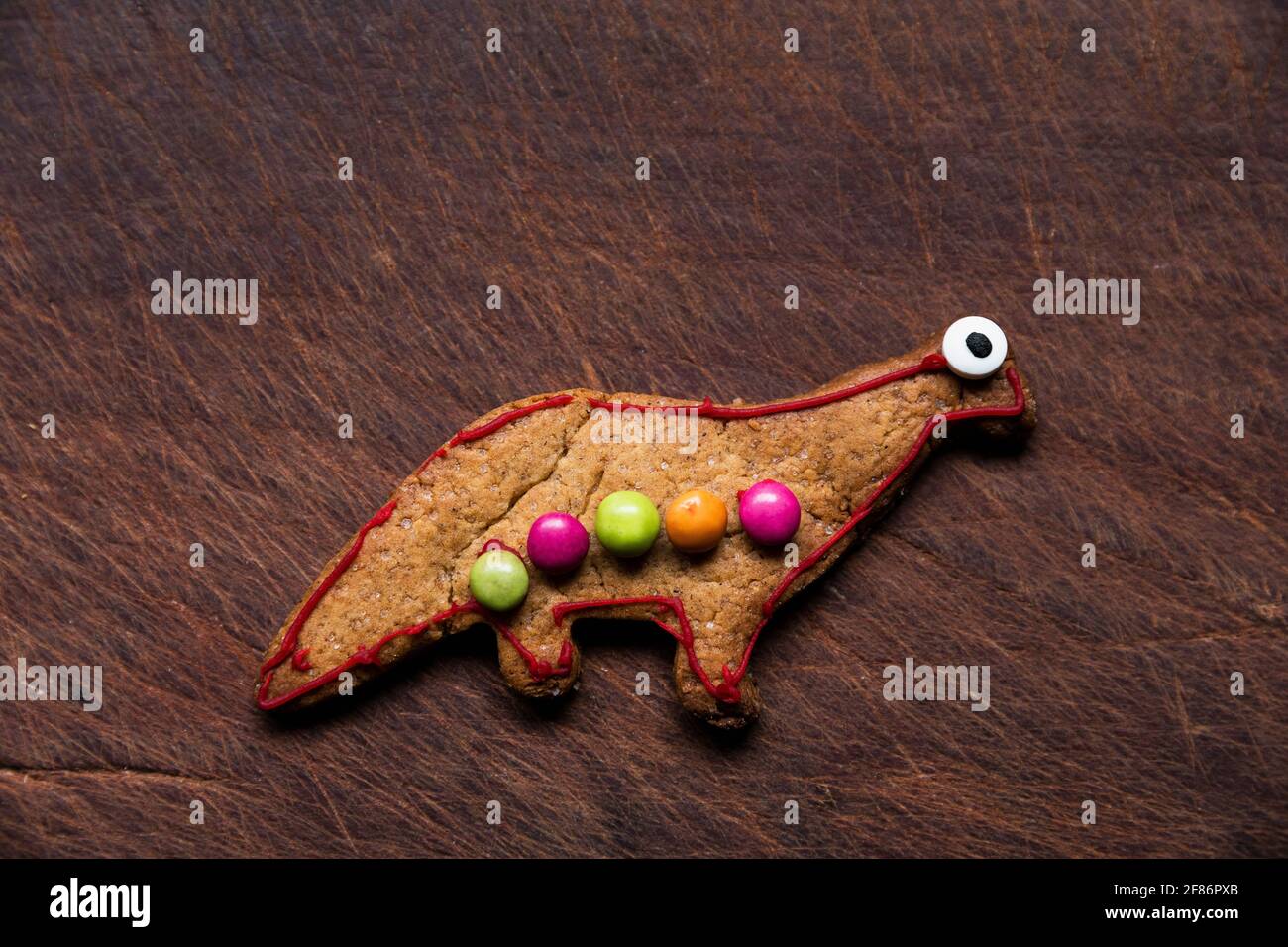 Cute decorated dinosaur gingerbread cookie Stock Photo