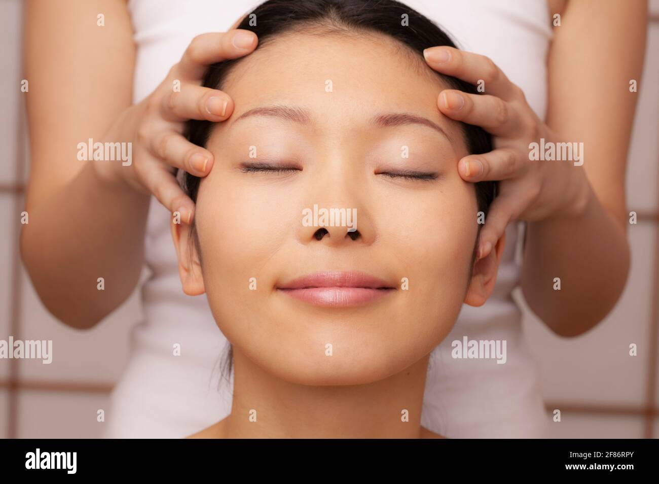 Close up serene young woman receiving scalp massage in spa Stock Photo