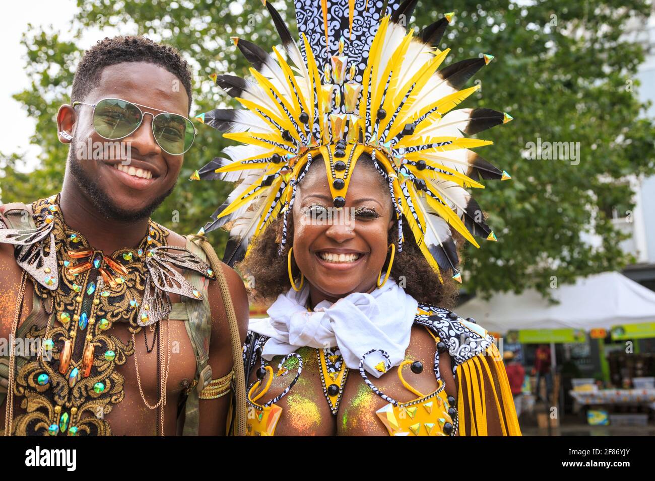 Afro-Caribbean  carnival participants in salsa costume, smiling at Notting Hill Carnival, London, England Stock Photo
