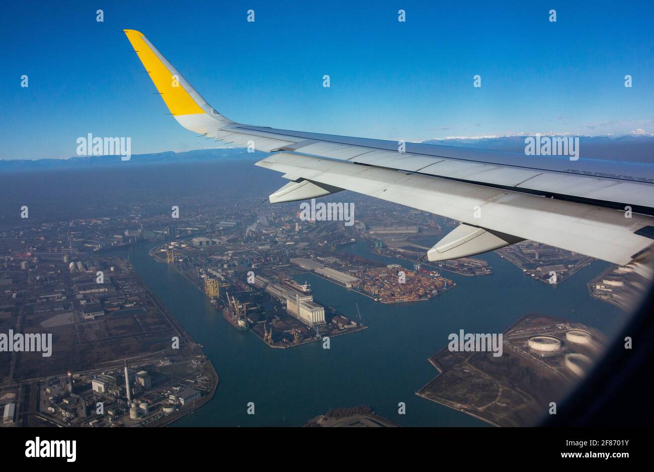 wing of plane over Venice Stock Photo