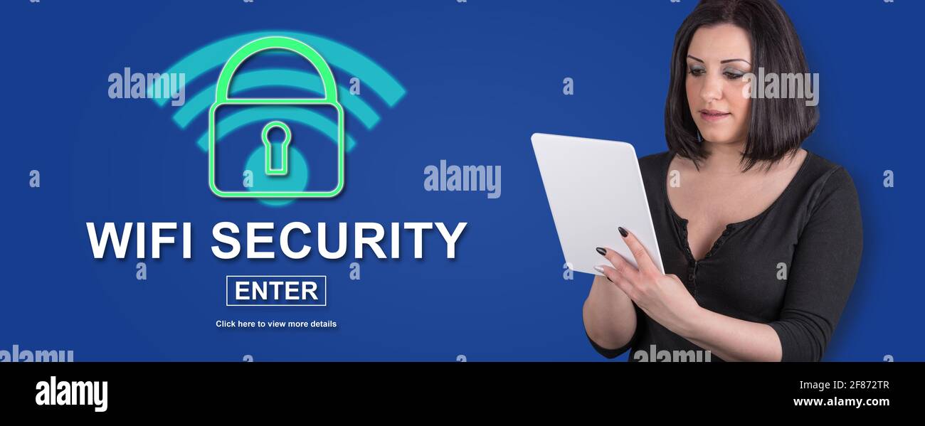 Woman using digital tablet with wifi security concept on background Stock Photo