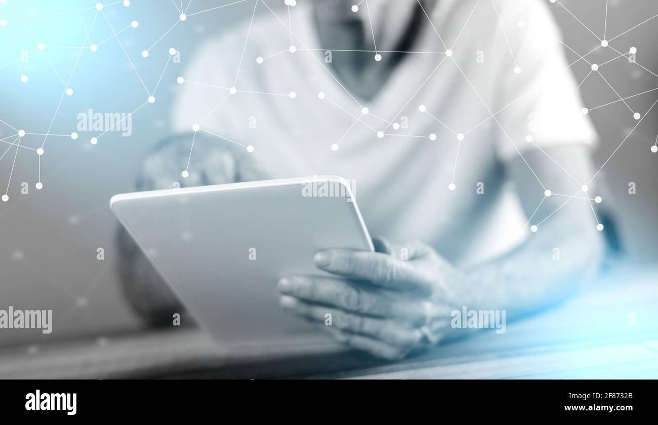 Man sitting using a tablet; multiple exposure Stock Photo - Alamy