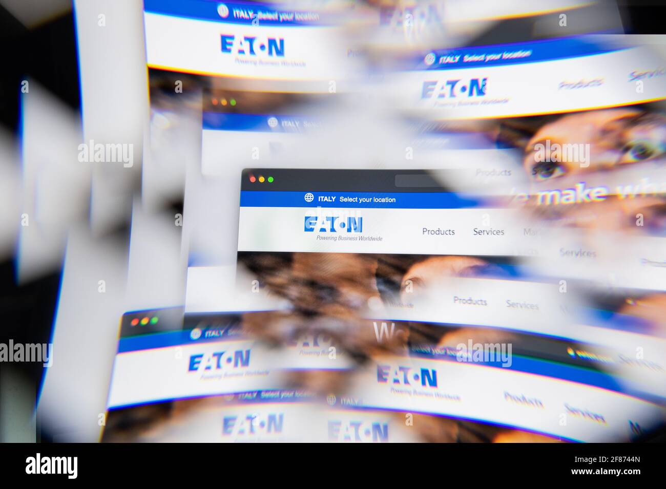 Milan, Italy - APRIL 10, 2021: Eaton Corporation logo on laptop screen seen through an optical prism. Illustrative editorial image from Eaton Corporat Stock Photo