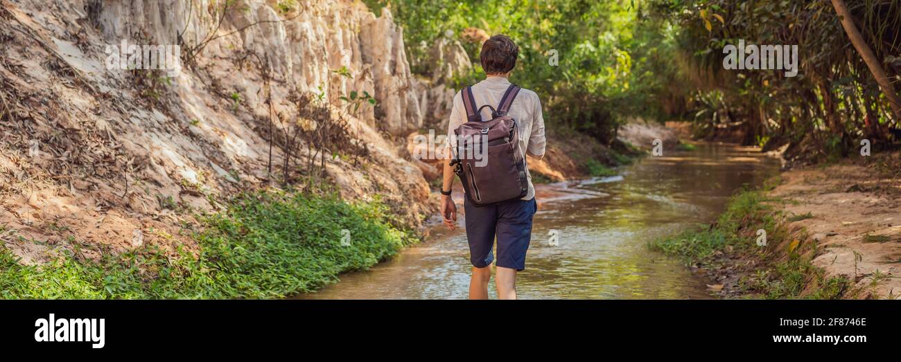 Man tourist on the Fairy stream among the red dunes, Muine, Vietnam. Vietnam opens borders after quarantine COVID 19 BANNER, LONG FORMAT Stock Photo