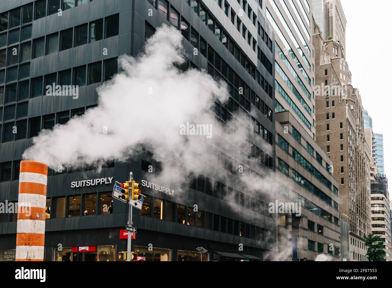 New York City, USA - June 24, 2018: Steam coming out stack for venting the district heating system in Midtown of New York. Climate Change and Carbon F Stock Photo