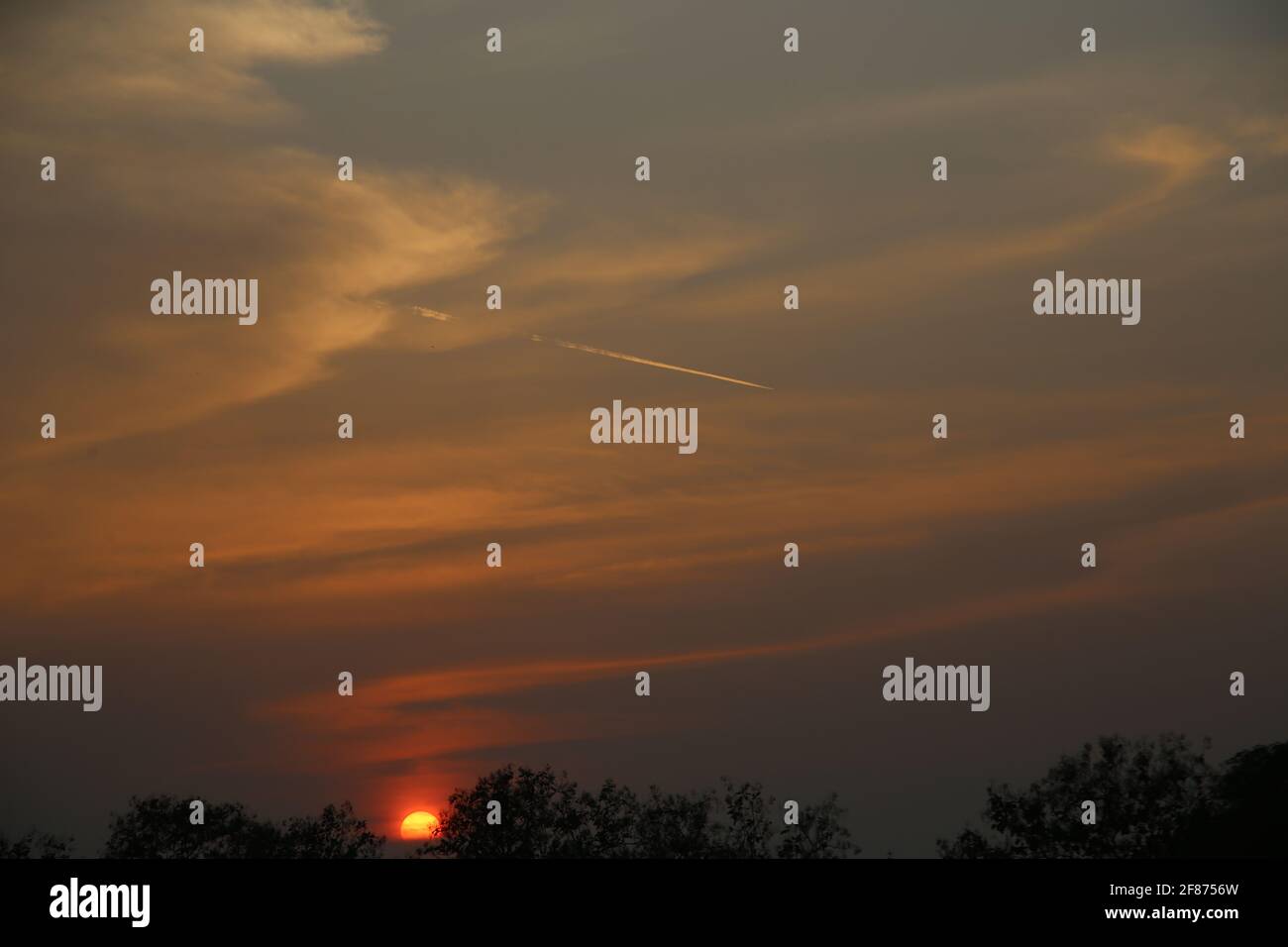 Beautiful sky during an orange sunset Stock Photo - Alamy