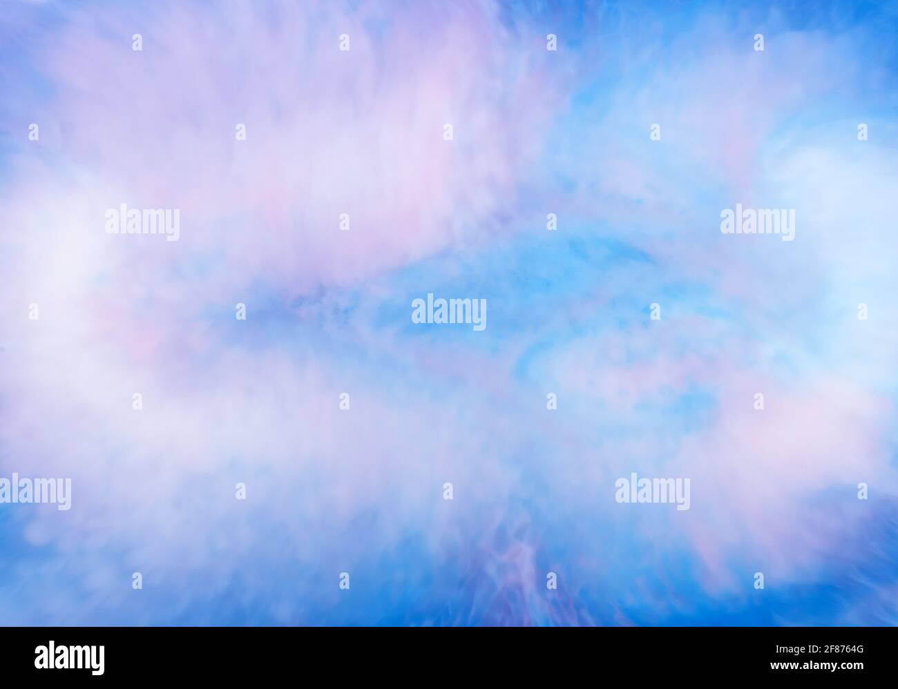 Ethereal background abstract pattern of blue ink blending in water with pink overtones for an artistic design template Stock Photo