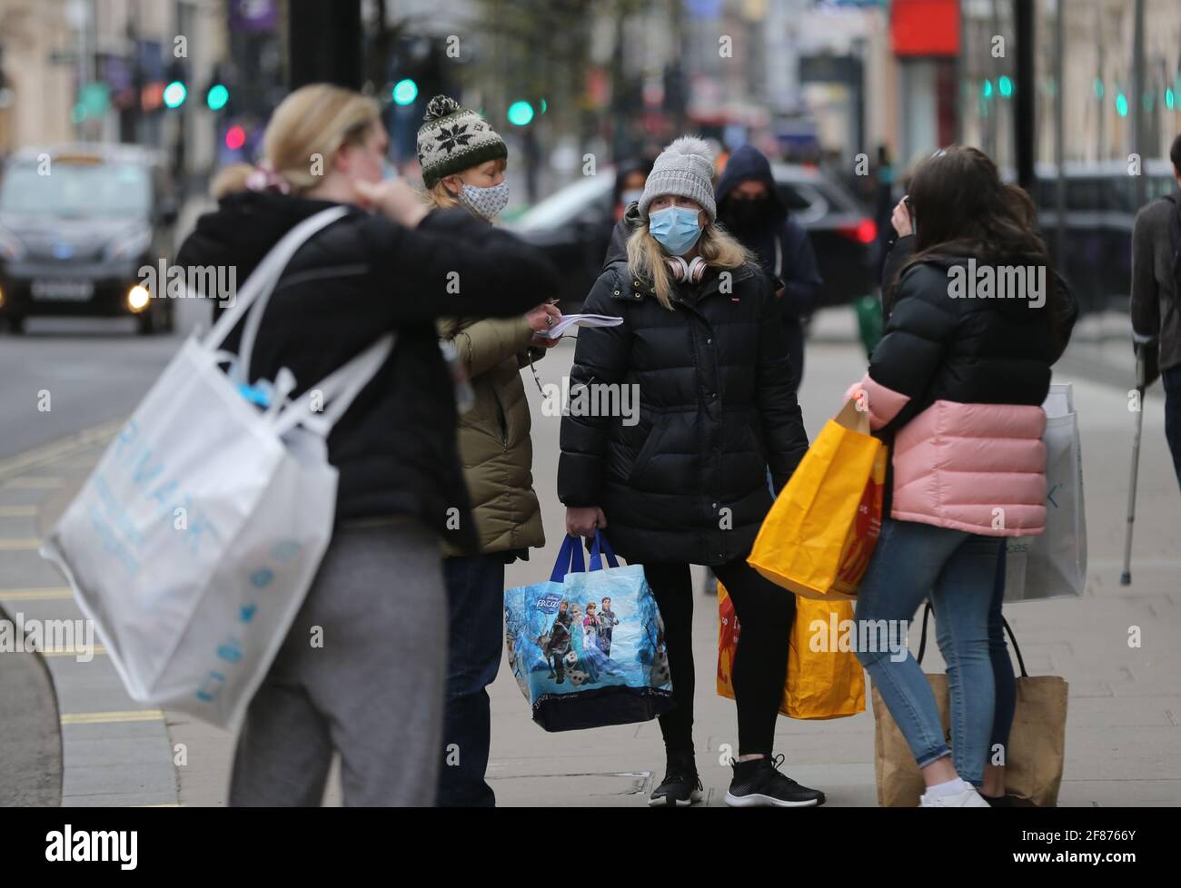 London, England, UK. 12th Apr, 2021. Shoppers are seen carrying bags on