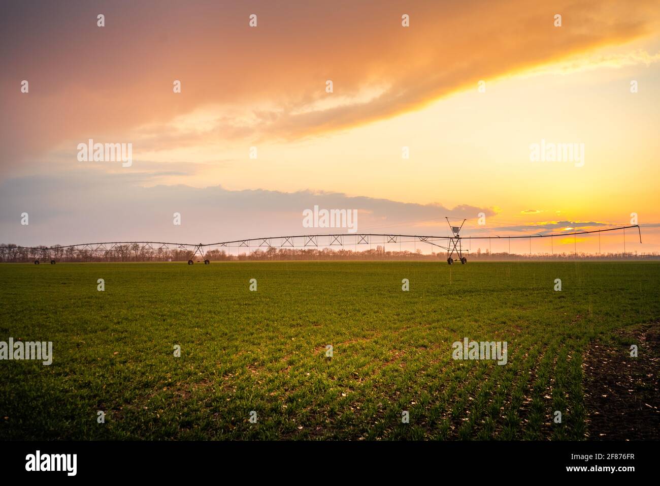 Automated farming irrigation system in sunset Stock Photo - Alamy