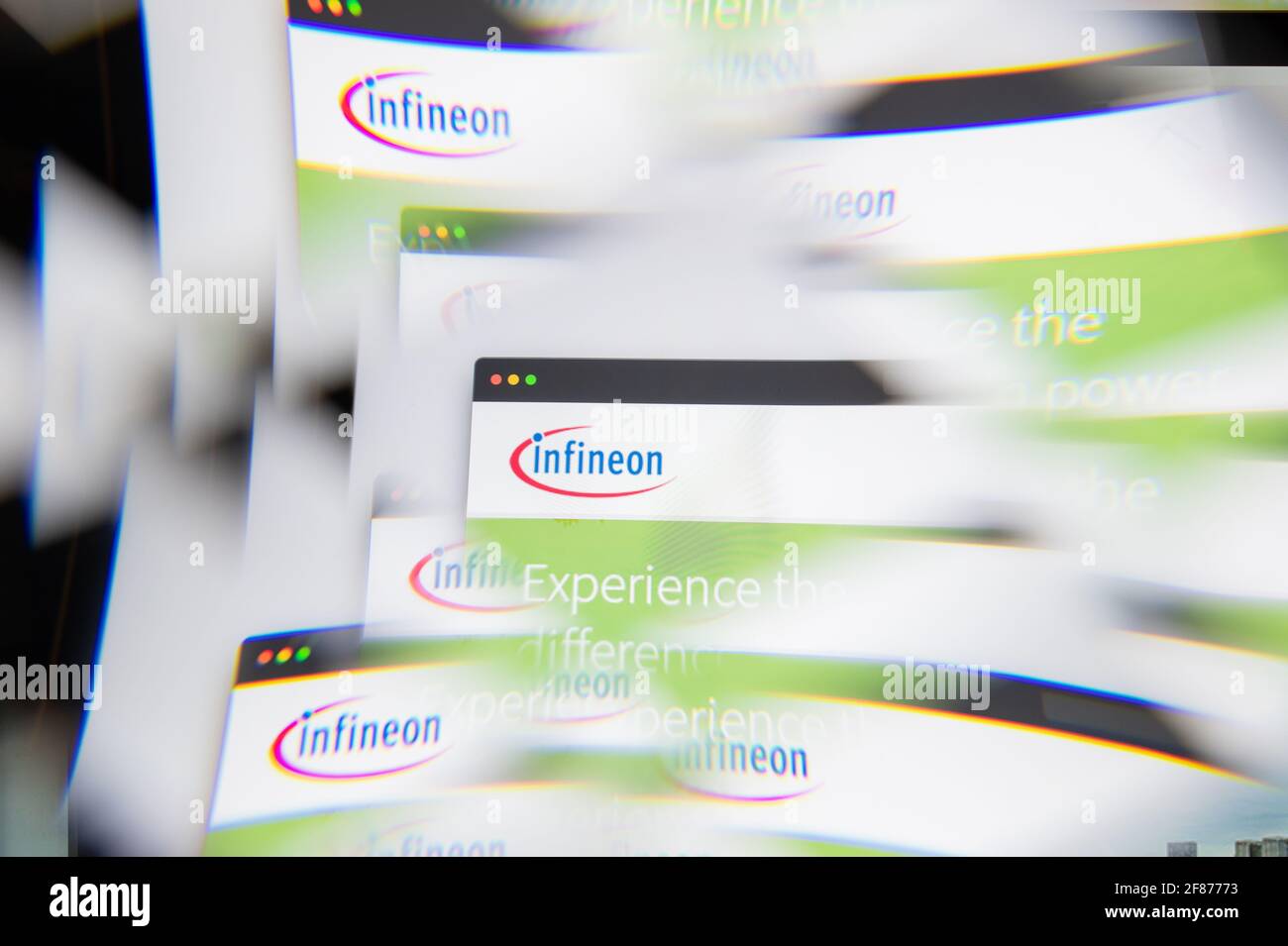 Milan, Italy - APRIL 10, 2021: Infineon Technologies logo on laptop screen seen through an optical prism. Illustrative editorial image from Infineon T Stock Photo