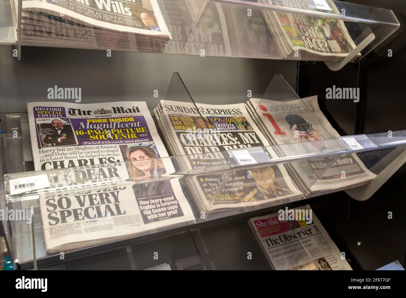 A newsstand inside a shop showing various newspapers for sale Stock Photo