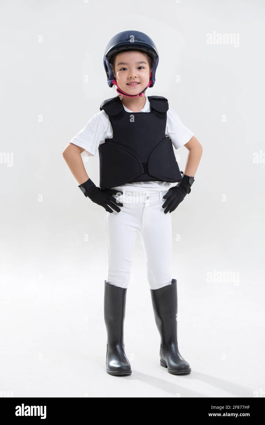 Little girl wearing riding clothes Stock Photo Alamy