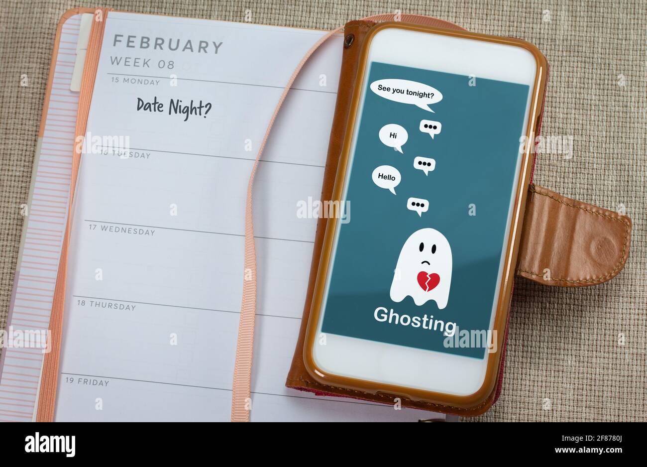 Ghosting on mobile phone on table with diary, Ghosted to cut all communication without explanation, ending a relationship. Social media dating. Stock Photo