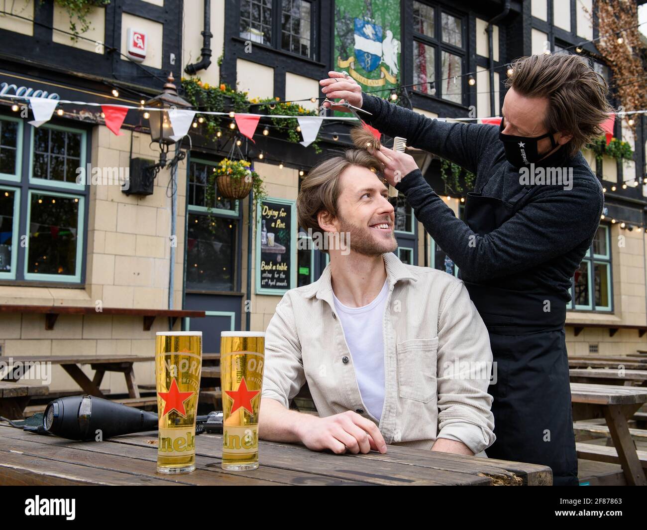 Editorial Use Only Joe Foyster receives a free haircut from Michael