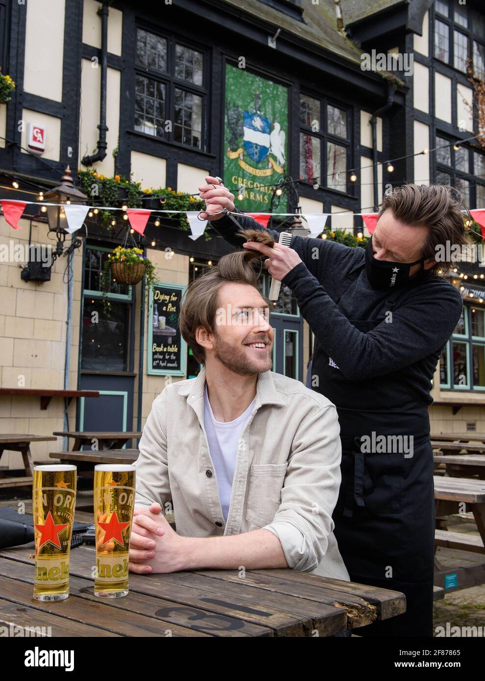 Editorial Use Only Joe Foyster receives a free haircut from Michael