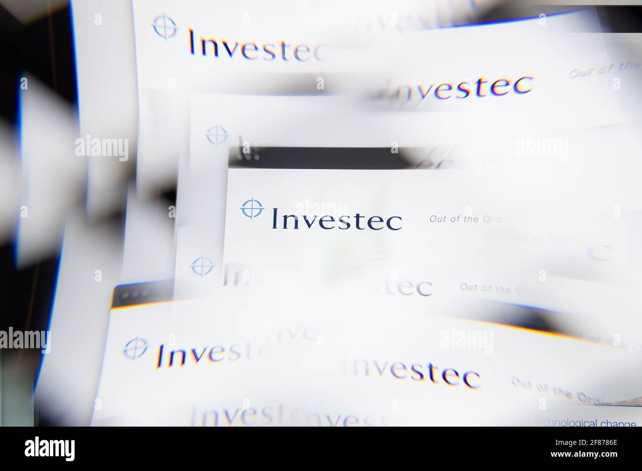 Milan, Italy - APRIL 10, 2021: Investec logo on laptop screen seen through an optical prism. Illustrative editorial image from Investec website. Stock Photo