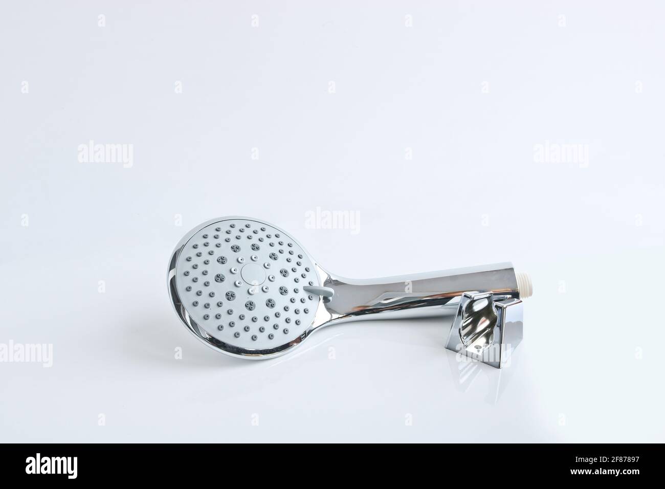 Shower head and wall mount on a light background. Plumbing accessories. Stock Photo