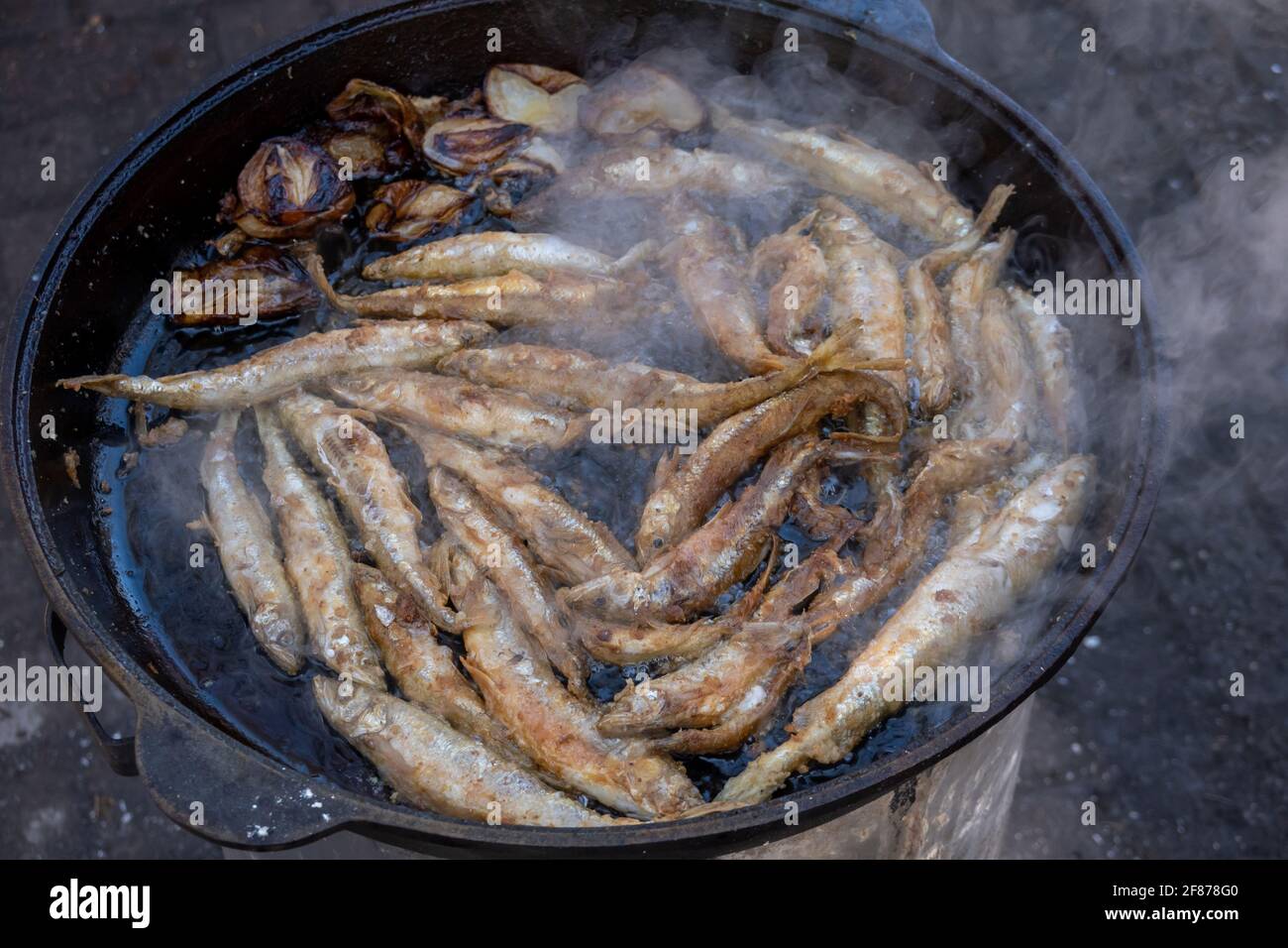 Fish frying in hot oil Stock Photo - Alamy